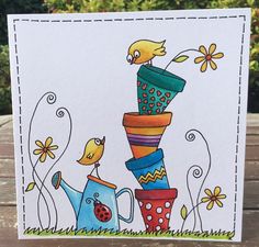 a handmade card with an image of a bird and watering can