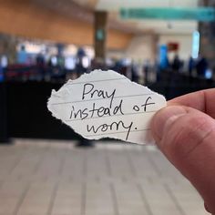 someone holding up a piece of paper that says pray instead of wony on it