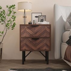 a night stand with two drawers next to a bed and potted plant on the side