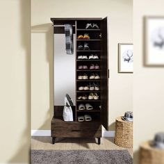 a wooden shoe rack with shoes on it in front of a mirror and rugs