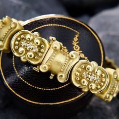 This bold and beautiful Etruscan style bracelet features fancy links reminiscent of ancient ionic columns, and diamond accented fancy links with lovely gold beadwork. The bracelet fits up to a 7.25 inch wrist and is crafted in 14k yellow gold with high polish and matte finishes. It has a double hidden box clasp and both a fold under and a figure-eight safety clasp. Ornate Yellow Gold Jubilee Bracelet, Luxury Gold Jewelry With Historical Design, Yellow Gold Byzantine Bracelet For Formal Occasions, Elegant Yellow Gold Bracelet With Decorative Band, Elegant Yellow Gold Bracelets With Decorative Band, Formal Yellow Gold Byzantine Bracelet, Formal Byzantine Yellow Gold Bracelets, Formal Byzantine Yellow Gold Bracelet, Elegant Gold Bracelet With Decorative Band