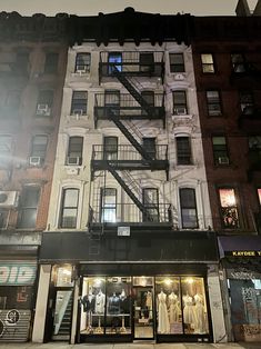 an apartment building with fire escape stairs on the side