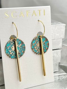 "These designs are barrel plated in brass and then hand painted with teal patina. The tubular bar and textured flat bar are rack plated with 18 K gold plating. Rack plating means that each piece is hung by hand so that they receive the optimal amount of coverage which creates a very glossy finish.   Available option are as follows: Round Shape with Hoop Heart Shape with Hoop Round Shape with Wire Hook The wire hoops and hooks are plated with 18 K gold. The hooks come with rubber back stoppers. The full length of the hook earring is 2 1/2 \" and the hoop earring is 2\" from the top of the hook or hoop down. The earrings are lead safe." Artistic Metal Dangle Earrings, Artistic Hammered Metal Earrings, Blue Hammered Drop Earrings, Artistic Brass Earrings Nickel Free, Artistic Green Metal Earrings, Artistic Single Brass Earring, Artistic Gold Earrings With Patina, Artistic Bronze Dangle Earrings, Artistic Brass Earrings