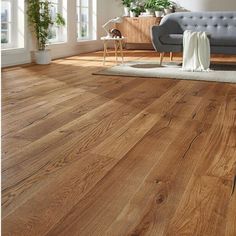 a living room with wood floors and furniture