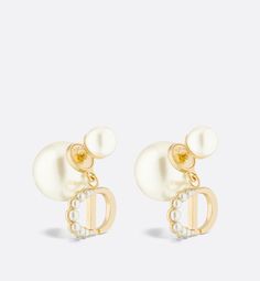 The elegant Dior Tribales earrings offer a new sleek, couture interpretation of an iconic House style. The hallmark pearls are adorned with the CD signature in gold-finish metal, embellished with small resin pearls in varying sizes adorning the letter C. Delicate and timeless, the earrings can be worn with creations from the 30 Montaigne line.. The Letter C, Couture Looks, Jeweled Earrings, Letter C, Gold Finish, Metallica, Gold Earrings, Cd, Dior