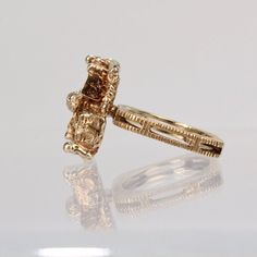 An exciting American Brutalist cocktail ring in 10K yellow gold.  The cast top rests on a square, textured split shank.   The interior of the shank is signed I. F. and marked for 10K gold fineness.  Simply a subtle, edgy statement ring!  Measurements: Width: ca. 11mm Length: ca. 17mm Height from shank: ca. 9mm  Ring Size: ca. 5 1/4  Weight: ca. 7.5 g Modernist 14k Gold Ring For Formal Occasions, Formal Modernist 14k Gold Ring, 14k Yellow Gold Square Cut Diamond Ring, Modernist Yellow Gold Wedding Jewelry, Modernist Yellow Gold Jewelry For Wedding, 14k Gold Open Ring With Lost Wax Casting, Heirloom Nugget Rings As Gift, Modernist Gold Rectangular Signet Ring, Modernist 14k Gold Formal Ring