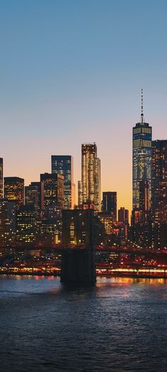 the city skyline is lit up at night