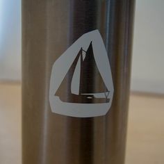 a bottle with a sailboat sticker on it