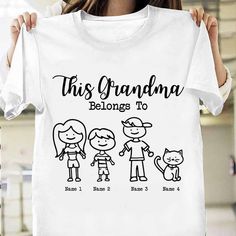 a woman holding up a t - shirt that says, this grandma belongs to three children