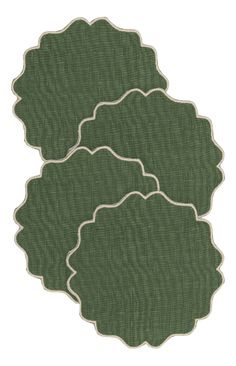 three green rugs with white trim on each side and an oval design in the middle