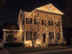 a large white house with christmas lights on it