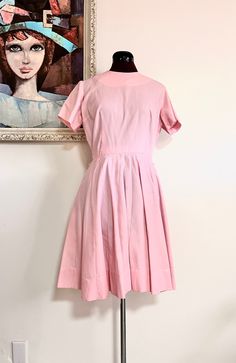 "Adorable 60s pink pleated knee length dress, by Kabro of Houston. It has a crew neckline, short sleeves and a detatchable belt, the skirt is pleated. Such a darling dress!  Material: Cotton Color/print: Pink Maker: Kabro of Houston Origin: US  Era: 50's/60's Size: M Measurements Bust- 39\"  Sleeve Length- 7\" Waist- 28\"  Hips- 71\" fully extended  Length- 36.5\" Condition: very good, pre-owned, the underarms have been crudely mended at seam Bust-taken from under the arm to under arm laying flat Sleeves-taken from under the arm to sleeve end Waist-taken from side to side laying flat Length-taken from shoulder to hem laying flat" Retro Dresses With Pleated Waist For Daywear, Pink Dress With Fitted Waist And Short Sleeves, Classic Short Sleeve Dress With Pleated Skirt, Summer Short Sleeve Dress With Accordion Pleats, Fitted Short Sleeve Dress With Accordion Pleats, Pink Retro Dress For Work, 1950s Style Short Sleeve Day Dresses, 1950s Style Short Sleeve Dresses For Daywear, Short Sleeve Dress With Pintucks For Work