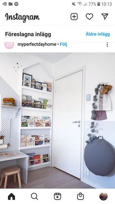 a room with white walls and shelves filled with books