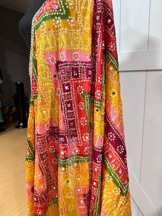 Experience the beauty of traditional Phulkari style with our Multicolor Dupatta. Made with a soft and luxurious silk finish, this dupatta features real mirror accents and stunning designs. Its heavy-weight construction makes it perfect for special occasions like Navaratri. Elevate your wardrobe with this must-have accessory. Approx 2.5 meters length Bohemian Sharara With Dupatta In Traditional Drape, Bohemian Sharara With Dupatta And Traditional Drape, Silk Traditional Wear With Gota Work, Bohemian Chanderi Anarkali Set With Gota Work, Bollywood Style Multicolor Anarkali Set For Festive Season, Unstitched Multicolor Anarkali Set For Navratri, Traditional Drape Multicolor Anarkali Set For Navratri, Multicolor Traditional Anarkali Set For Navratri, Festive Multicolor Silk Anarkali Set