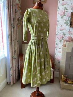 Pretty cotton fit and flare dress from 1950s.  Zips at back.  Good vintage condition  Armpit across 36" would fit max 34" bust well.  Waist 28" Length 42" Fitted Green Floral Vintage Dress, Fitted Green Vintage Dress With Floral Print, 1950s Style White Cotton Dress, 1950s Style Green A-line Dress, 1950s Style Green Dress For Garden Party, White Cotton 1950s Style Dress, 1950s White Cotton Dress, 1950s Style Cotton Dress For Garden Party, Green A-line Cotton Vintage Dress