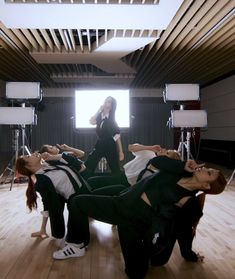 a group of people standing on top of a wooden floor