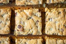 several squares of food sitting on top of a wooden table