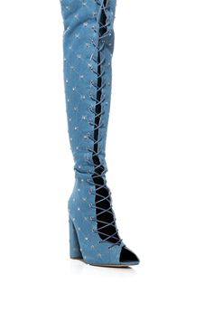 Show up and show out in The Living Legend Lace Up Open Toe Thigh High Boot in Denim. This washed denim thigh high boot features an open almond toe silhouette, a lace up front, a chunky heel, and silver metallic detailing. Complete with rhinestone studded accents, quilted embroidery detailing, and a tonal back zipper closure. Pair with a denim mini, a button down top, and an oversized jacket for a legendary look. (all measurements approximate from size 7.5): - Denim Textile Upper - Almond Toe - Chunky Heel - 24” Shaft Height - 4.75” Heel Height - 20.5’ Shaft Circumference - 12” Calf Circumference - Imported Product ID: 373946 Open Toe Boots, Crystal Belt, Embroidery Detailing, Chic Leather, Denim And Lace, Living Legends, Oversized Jacket, Rhinestone Studs, Washed Denim