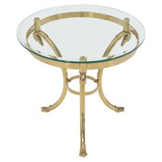 a round glass table with gold metal legs