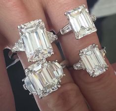 three emerald cut diamond rings on someone's finger