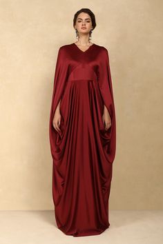 Buy Maroon Crepe Satin Plain Solid V Neck Draped Cape Gown For Women by Dania Siddiqui Online at Aza Fashions. Cowl Skirt, Maroon Gown, Draped Gown, Party Reception, Cape Gown, Drape Gowns, Gown For Women, Cape Sleeves, Gowns Online