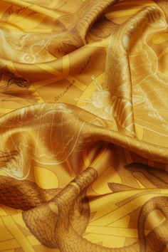 an orange and gold fabric with birds on it