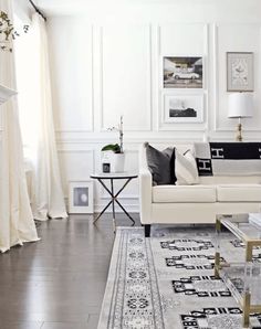 a living room filled with furniture and white walls