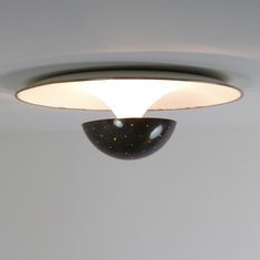 a black and white bowl hanging from the ceiling