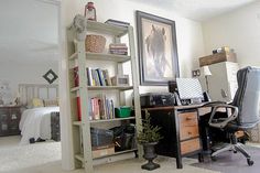 a home office with bookshelves, desk and chair