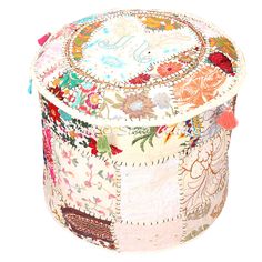 a multicolored patchwork round box with tassels