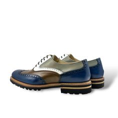 Also known as a wingtip, the Full Brogue is easily identifiable as one of the most classic pairs of dress shoes on the market. Featuring a brogue pattern along the sides as well as the toe cap, everyone needs a Full Brogue in their shoe closet. NOTE: All unisex styles are in women's sizing, to choose MENS choose two sizes UP and WIDE option. Details: Materials: grey painted italian calf + navy painted italian calf + Med brown box italian calf Lining: beige calf leather Sole: leather rubber sole Office Wingtip Lace-up Shoes With Contrast Sole, Wingtip Oxfords With Contrast Sole For Work, Blue Wingtip Oxfords With Brogue Detailing, Workwear Wingtip Oxfords With Contrast Sole, Wingtip Dress Shoes With Rubber Sole For Derby, Wingtip Dress Shoes With Rubber Heel Cap For Derby, Business Wingtip Lace-up Shoes With Contrast Sole, Wingtip Lace-up Shoes With Leather Sole, Goodyear Welted Wingtip Lace-up Derby Shoes