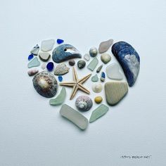 a heart made out of sea glass and seashells