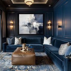 a living room filled with blue couches and pillows in front of a painting on the wall