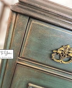 an antique dresser with gold handles and ornate knobs on the door handle is shown