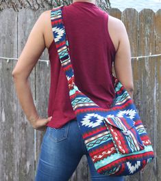 "Gorgeous Handmade Bottle Bag with zipper, front pocket, and Cross-body Strap. We design our Shoulder and Cross-body bags to be beautiful, ergonomic, functional, and durable. A resilient bag to carry your belongings to the gym, yoga studio, beach, camping, traveling, office, shopping, and all your daily activities. - 100% Handcrafted - Handmade products may vary slightly in design - Roomy Interior - Lightweight 1 lb. - Tribal Patterns - Durable Approx sizes: Bag: 9\" wide x 9\" height Length of Shoulder Yoga, Boho Cross, Yoga Photos, Boho Handmade, Bag With Zipper, Blue Bottle, Tassel Bag, Beach Camping, Teal And Pink