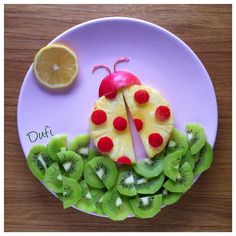 a lady bug made out of fruit on a plate