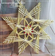 an ornament made out of sticks with red beads