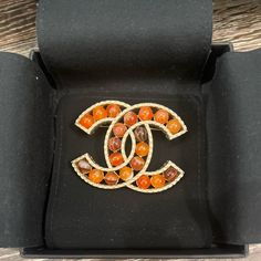 From The Cruise 2018 Collection By Karl Lagerfeld Gold-Plated & Orange Stone Includes Designer Box, Jewelry Pouch And Bag Length 1.5” Width: 2" Metal Type: Gold-Plated Marks: Designer Signature, Date Code, Made In France Total Item Weight (G): 29.4 Luxury Multicolor Brooches For Gifts, Luxury Multicolor Brooches As Gift, Orange Brooch Jewelry For Formal Occasions, Elegant Orange Brooch Jewelry, Formal Orange Brooch Jewelry, Elegant Orange Brooches For Gifts, Chanel Brooch, Orange Stone, Chanel Accessories