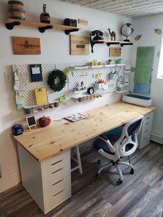 a home office with lots of shelves and desks on the wall, along with other items