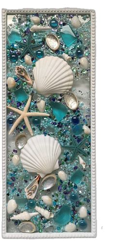 sea shells and seashells are on the bottom of this mosaic tile wall art