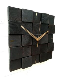 a clock made out of wooden blocks with gold hands