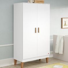 a white cabinet with two doors in a room