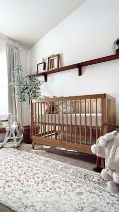 a baby crib in the corner of a room with a rug on the floor