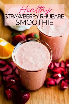 two glasses of strawberry rhubarb smoothie on a wooden table