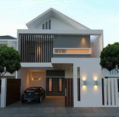 a car is parked in front of a modern house with lights on the windows and doors