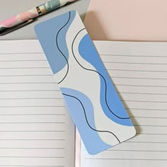 an open notebook with a notepad and pen next to it