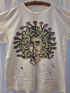 Alice Cooper 1997 Rock & Roll Carnival Local Crew XL T-Shirt paint splatter across bottom of shirt Relaxed Fit Paint Splatter T-shirt With Crew Neck, Streetwear Cotton Tops With Paint Splatter, Cotton Paint Splatter Tops For Streetwear, Casual Paint Splatter T-shirt For Streetwear, Short Sleeve Graphic Tee With Paint Splatter, Casual T-shirt With Paint Splatter For Streetwear, Graphic Tee With Paint Splatter And Crew Neck, Paint Splatter Graphic Tee With Crew Neck, Grunge Crew Neck Shirt With Graffiti Print