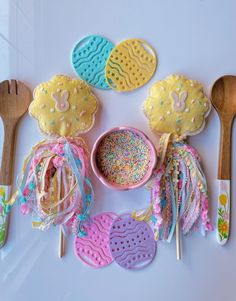 decorated cookies and spoons on a white surface