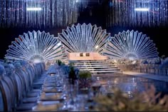 an elaborately decorated dining room with chandelier hanging from the ceiling and tables set for dinner