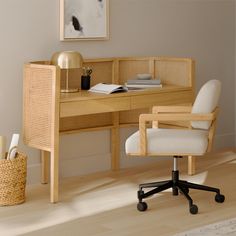 a chair and desk in a room with wood flooring next to a painting on the wall